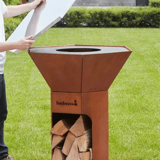 Rust-colored steel fire pit with sleek geometric design and barbecook logo on side for nestor cover plate bc-acc-7457