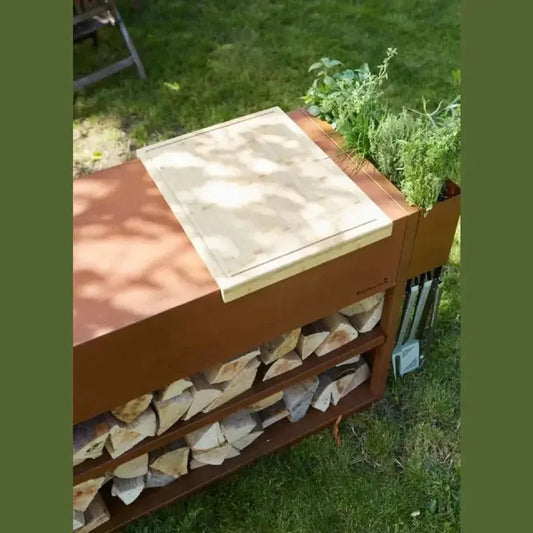 Rust-colored metal outdoor fire pit with built-in herb garden and stacked wood shelves for Barbecook Cutting Board BC-ACC-7483