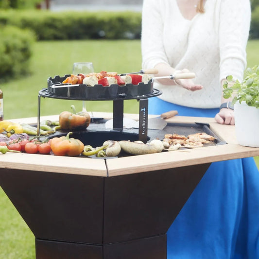 Black two-tiered outdoor bi-ba-cook grill with circular top rack and flat bottom cooking surface for barbecook side tables