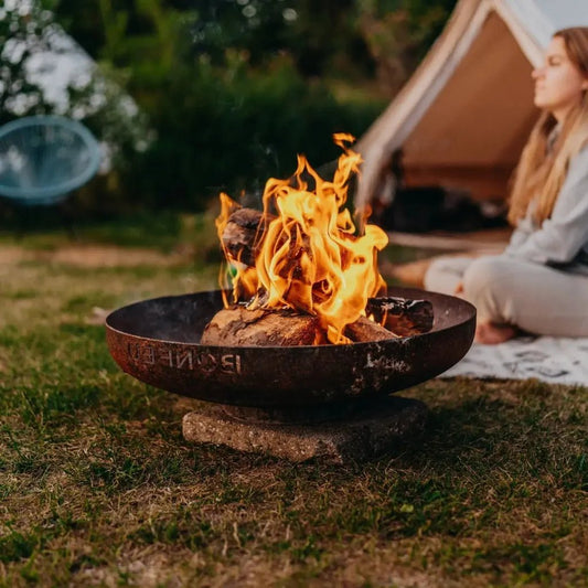 Rustic black metal bonfeu bonbowl corten steel fire bowl fire pit with flames burning inside for outdoor use