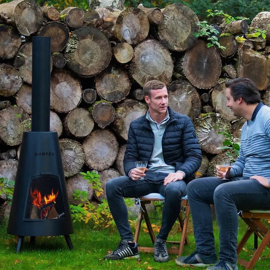 Black bonfeu bonpyra large outdoor fireplace with visible flames inside its conical metal body
