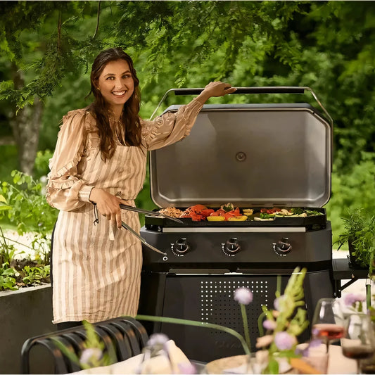Black gas grill cozze cart 800-series with stainless steel lid and control knobs for outdoor cooking