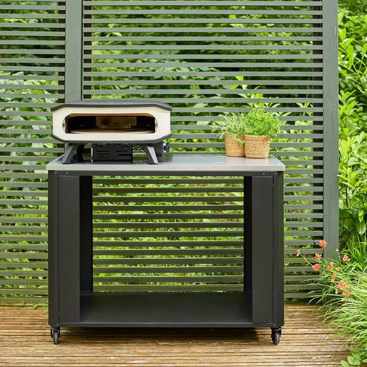 Black metal outdoor pizza oven with white ceramic interior on matching black cart from cozze outdoor kitchen 115