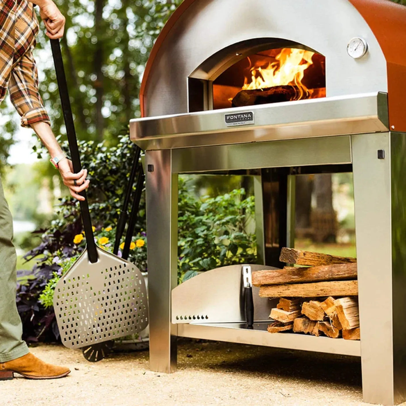 Stainless steel and copper fontana mangiafuoco anthracite wood-fired pizza oven with visible fire inside