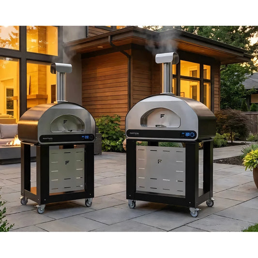 Two sleek stainless steel fontana volta 90 stand outdoor pizza ovens with black frames and casters
