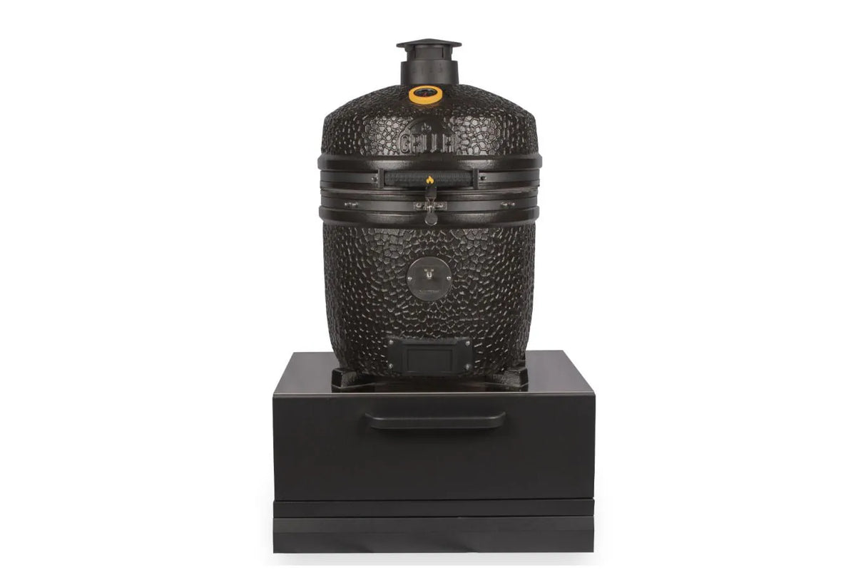 Black textured ceramic grill with pebbled surface and metallic accents in grllr connect kamado low unit cabinet