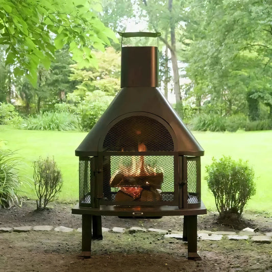 Heat saga outdoor fireplace in dark bronze metal with mesh front and arched top burning logs inside