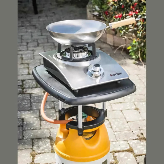 Silver stainless steel wok on a portable gas stove with an orange propane tank hot wok silver line hw2113