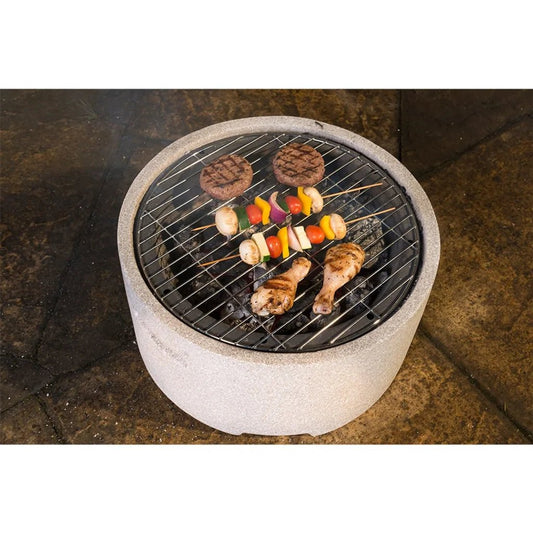 Round concrete Lifestyle Adena MGO fire pit with black metal grate cooking food on top