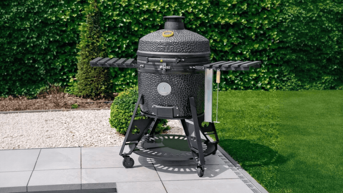 Black textured ceramic grill with round lid and metal legs ideal for best outdoor kitchens for summer entertaining in the uk