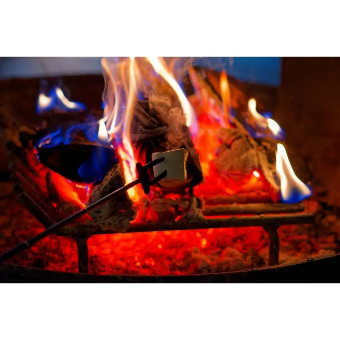 A white marshmallow roasting over blue and orange flames illustrating common fire pit cooking issues.