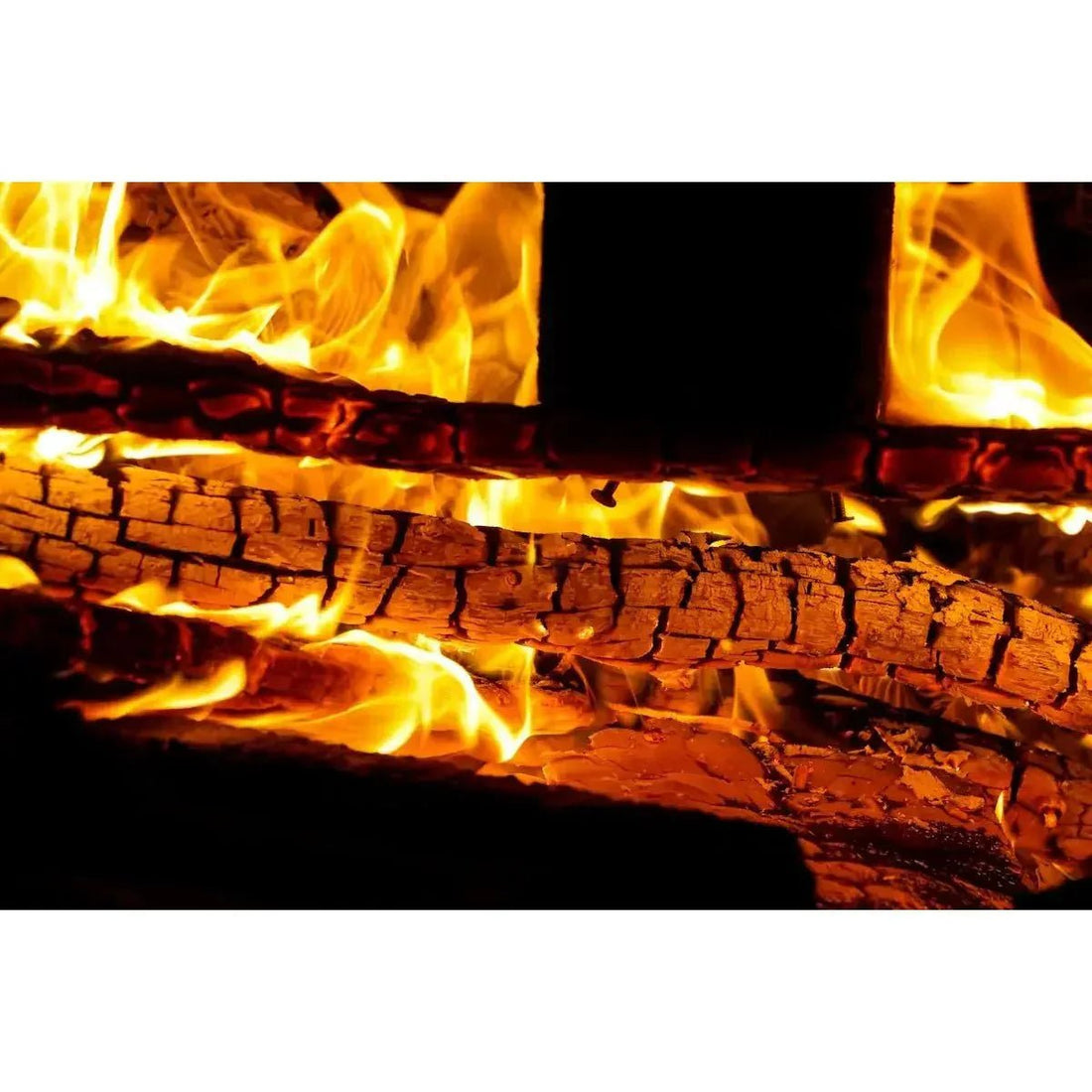 Burnt wood logs glowing with orange and yellow flames in an outdoor fireplace for safe installation tips
