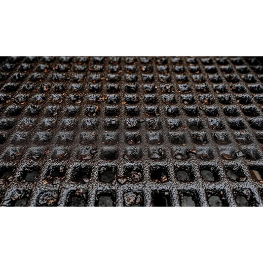 Black rubber BBQ mat with textured grid pattern designed for easy cleaning and maintenance of grills