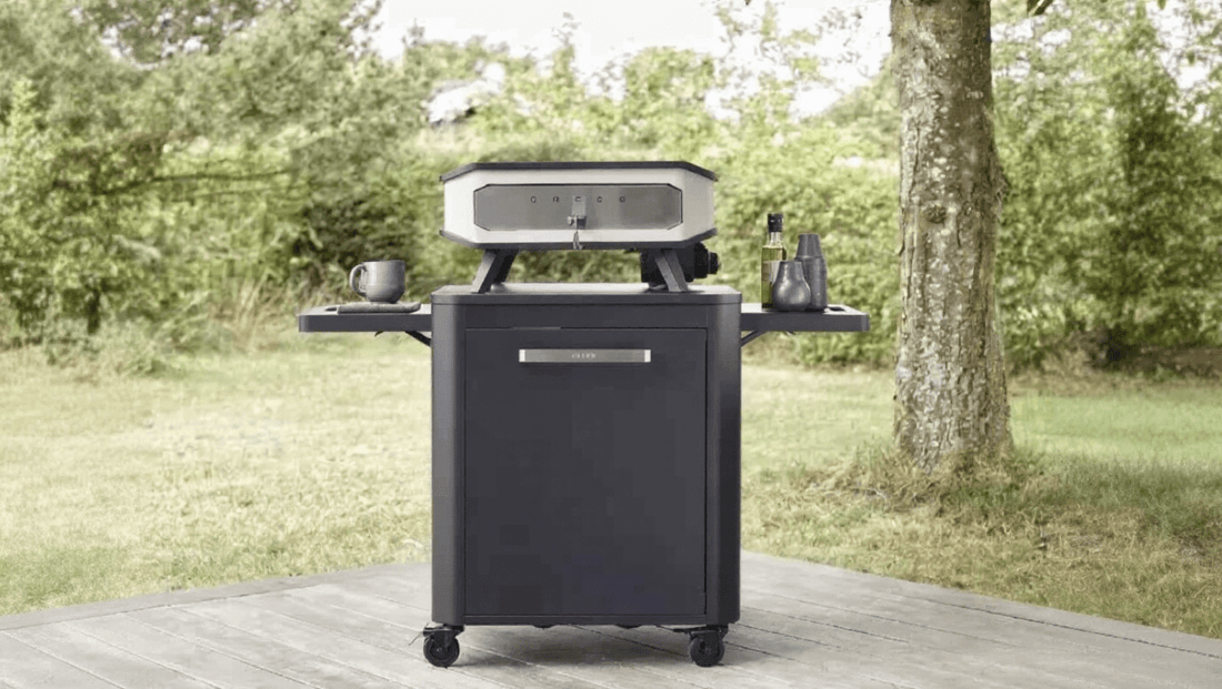 Black wheeled outdoor grill with silver control panel and side shelves ideal for UK outdoor kitchen setups.
