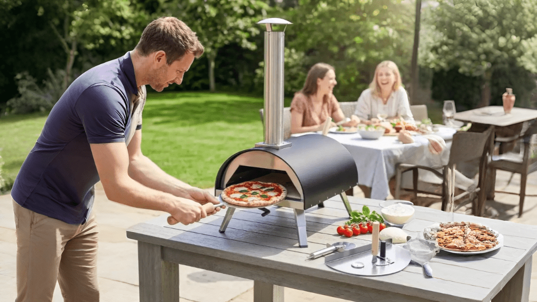 Black stainless steel outdoor pizza oven with tall chimney and four legs for family or garden use