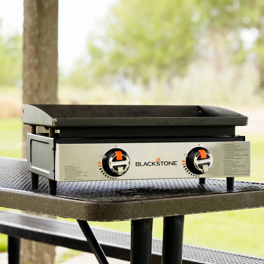 Blackstone 22 inch tabletop two-burner outdoor griddle with black cooking surface and stainless steel front panel