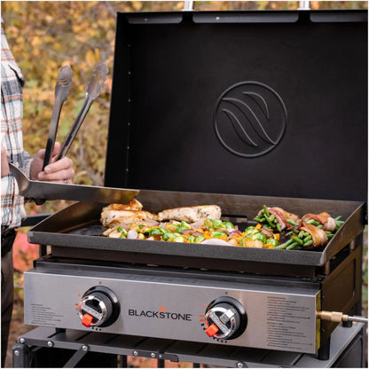Blackstone 22 inch tabletop portable gas grill with black griddle surface and stainless steel control panel with two knobs