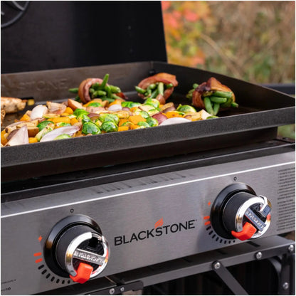 Blackstone 22 inch tabletop griddle with hood featuring a black cooking surface and silver control knobs