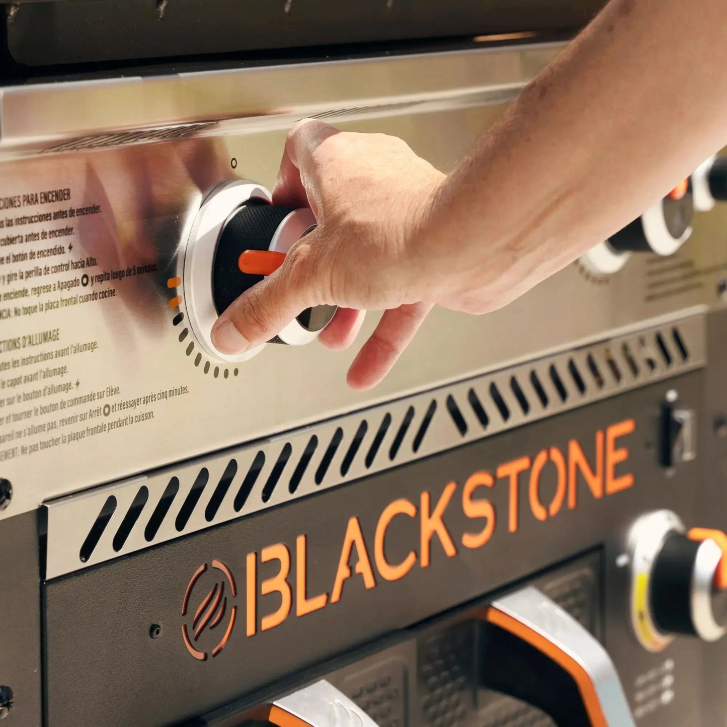 Blackstone 28 inch griddle with air fryer control knob featuring black and white dial orange handle stainless steel housing