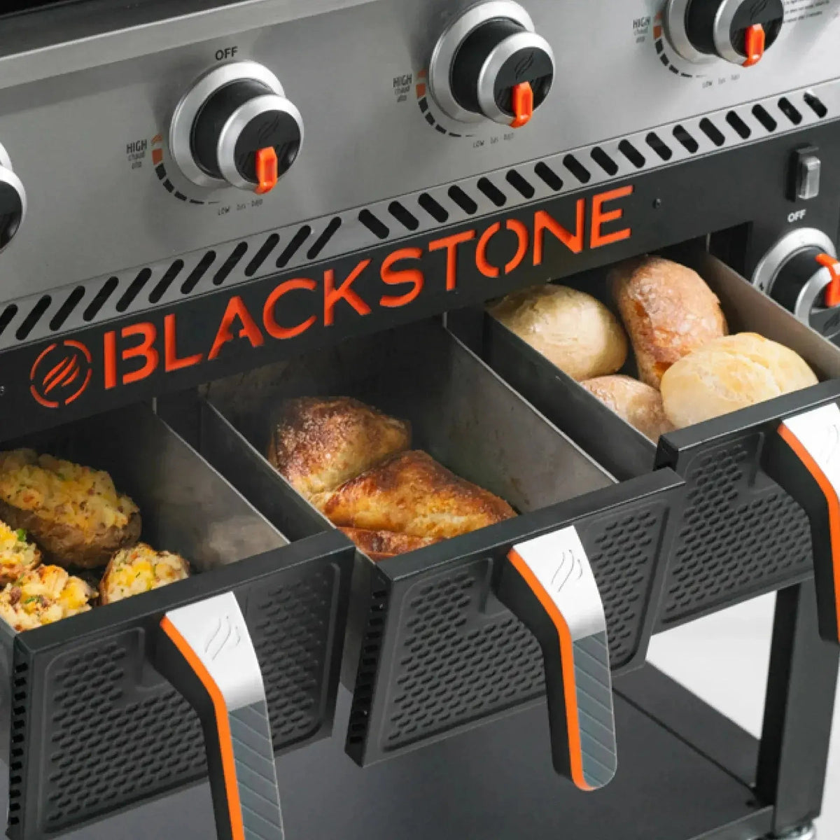 Blackstone 36 inch griddle with air fryers in black and orange featuring three compartments with roasted chicken and potatoes