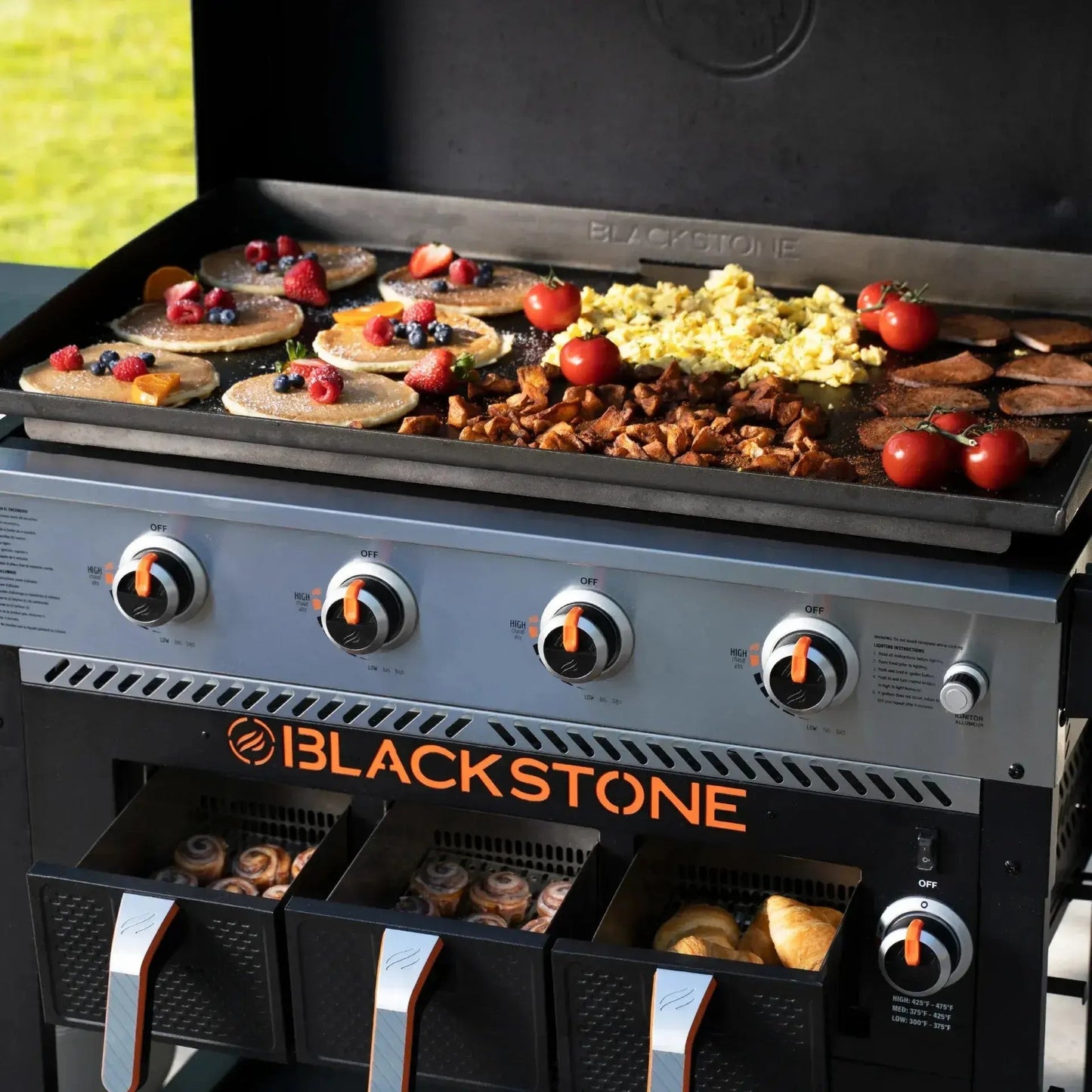 Blackstone 36 inch black gas grill with large flat metal griddle surface and built-in storage drawers for outdoor cooking