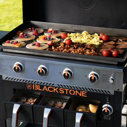 Blackstone 36 inch black gas grill with large flat metal griddle surface and built-in storage drawers for outdoor cooking