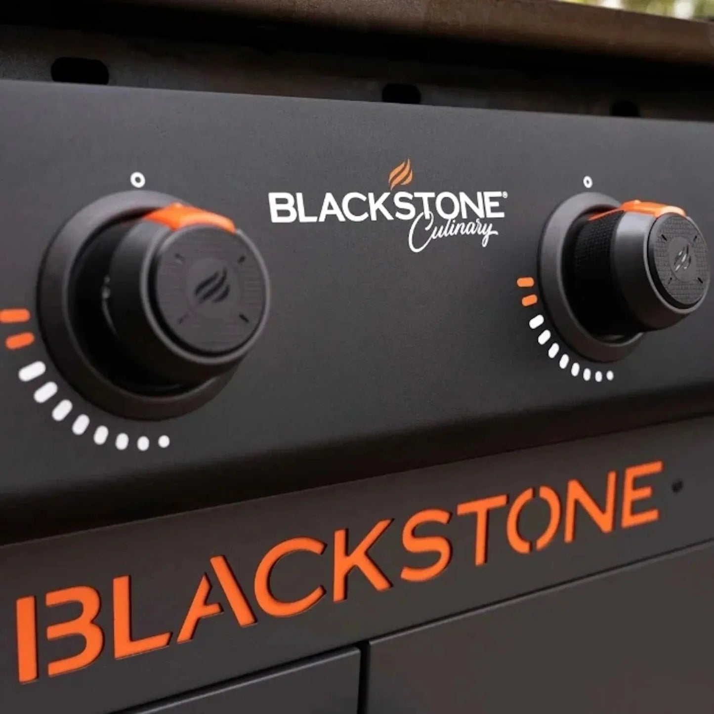 Blackstone culinary 36 inch griddle control panel with black matte finish and orange accents on knobs and branding