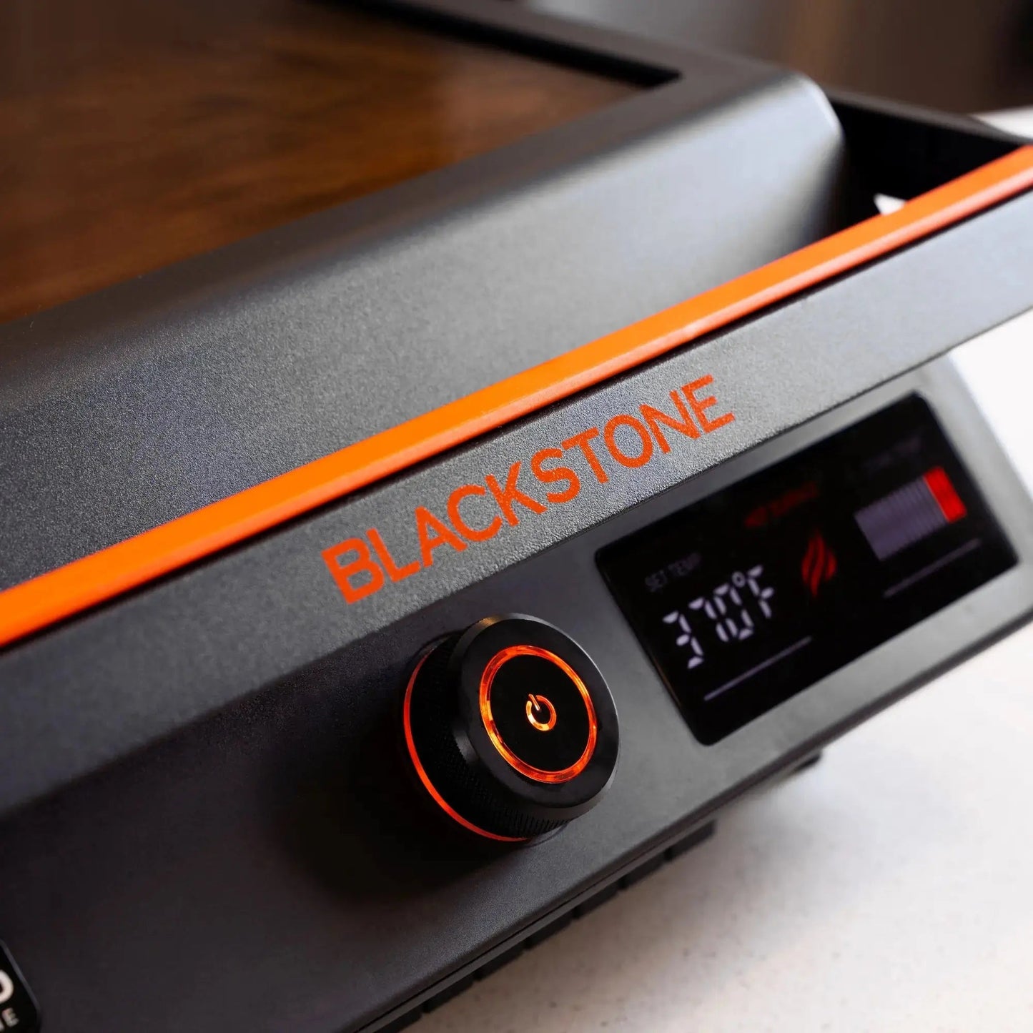 Blackstone e series 17 electric tabletop griddle with matte black body orange trim and illuminated control panel