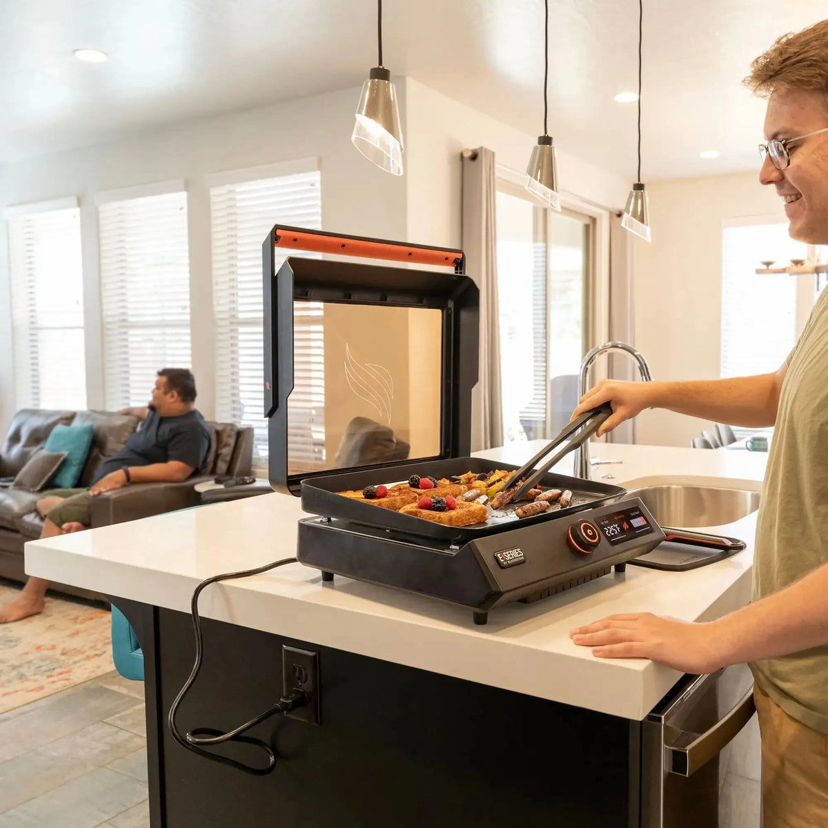 Blackstone e-series 17 inch electric tabletop griddle with black and orange design and digital temperature display