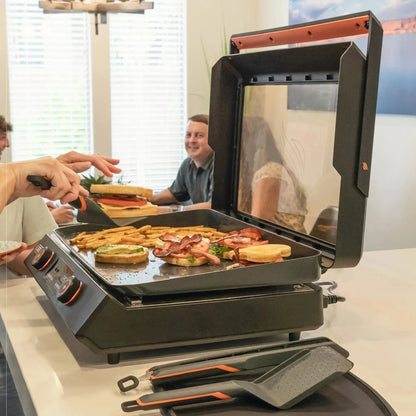 Blackstone E-Series 22 inch black and orange electric griddle with glass lid and multiple cooking zones for bacon eggs fries