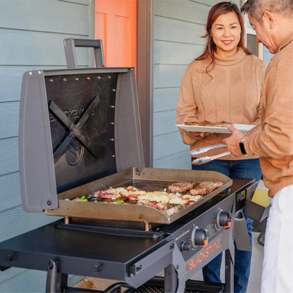 Blackstone iron forged 28 inch gray gas grill with flat-top cooking surface and hinged hood for outdoor cooking
