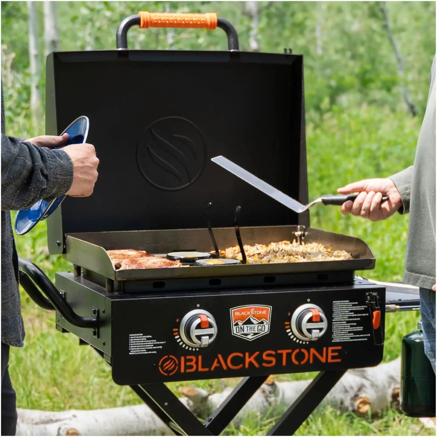 Blackstone otg 22 inch portable gas grill with black body orange handle and control knobs with flexfold legs