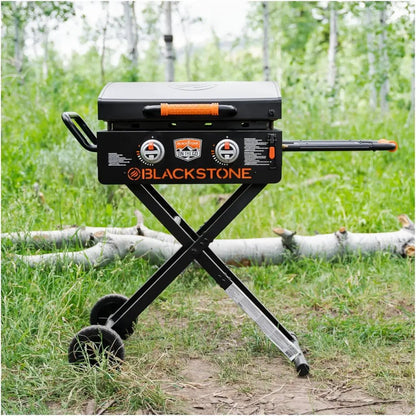 Blackstone otg 22 inch portable gas grill with black body orange accents and foldable x frame flexfold legs stand