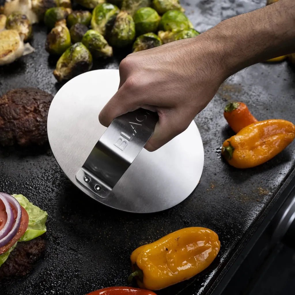 Stainless steel burger press with sleek flat design and engraved branding from blackstone smash burger kit