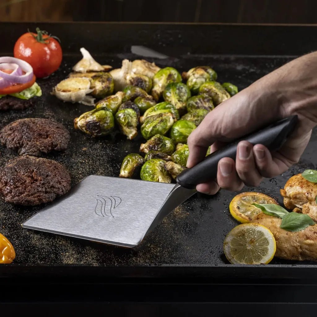 Silver stainless steel griddle spatula with black handle and wave logo in Blackstone Smash Burger Kit 3-piece set