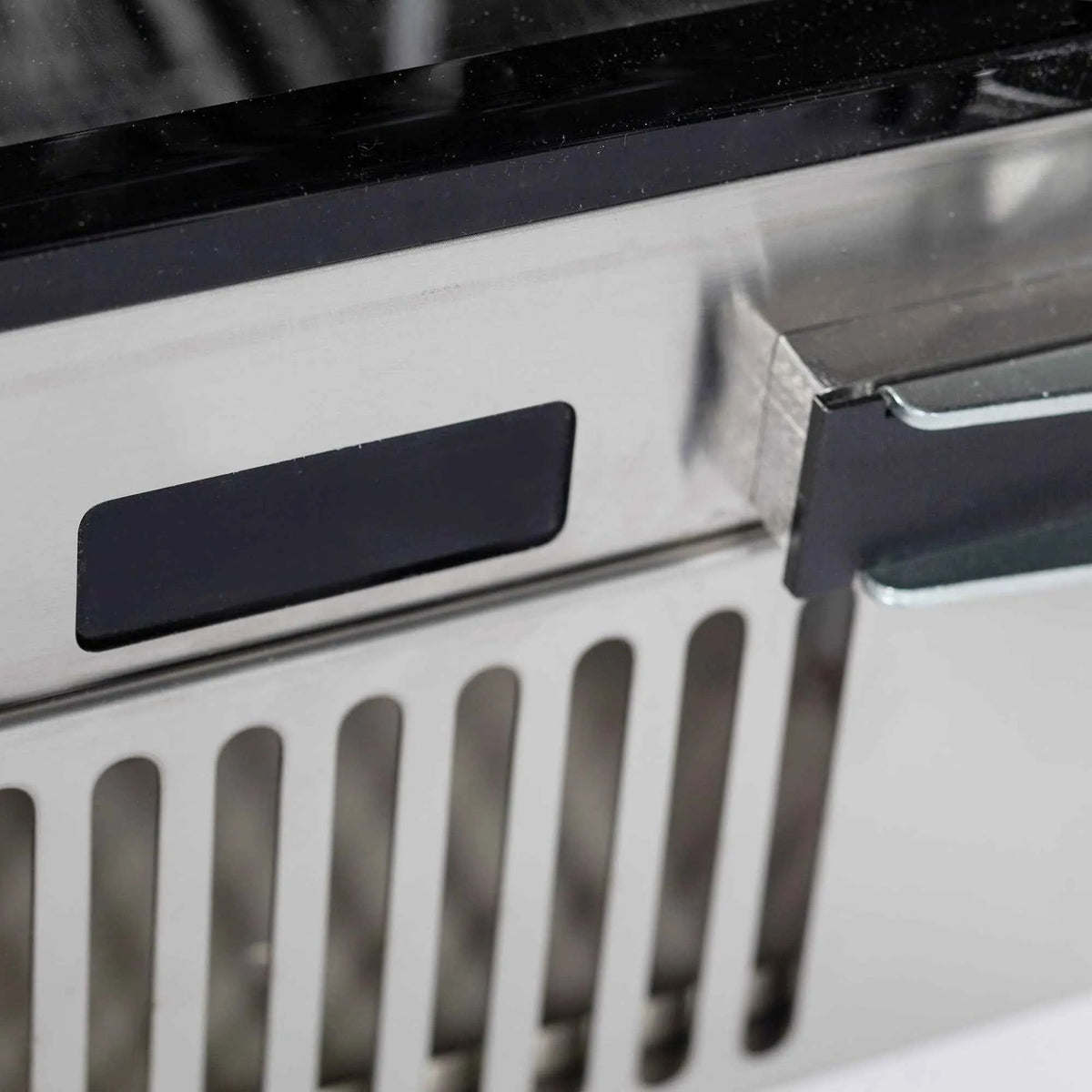 Blastcool extremis ixp1 integrated outdoor fridge with black rectangular handle and stainless steel vertical grille