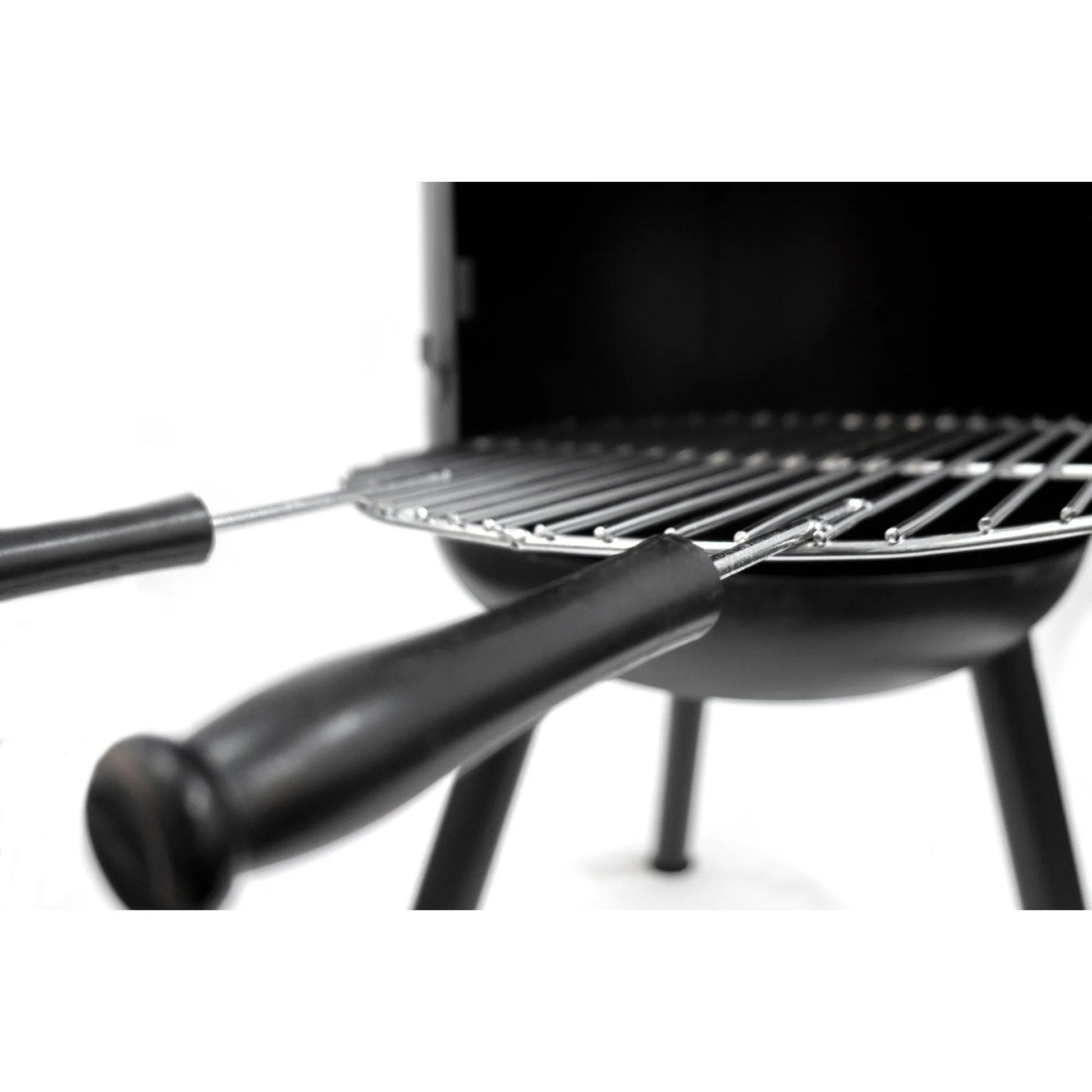 Black BonFeu BonBono large outdoor fireplace with metal grilling rack and two black-handled skewers