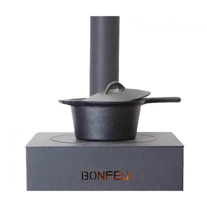 Black cast iron pot with matching lid and handle on gray stove base in bonfeu boncarré outdoor fireplace black 3503