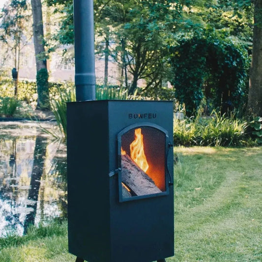 Black metal outdoor wood-burning stove with fire inside and bonfeu brand engraved front bonfeu boncarré 3503
