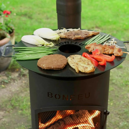 Black cast iron bonfeu bongiano lp outdoor fireplace grill top with circular cooking surface and central hole for grilling