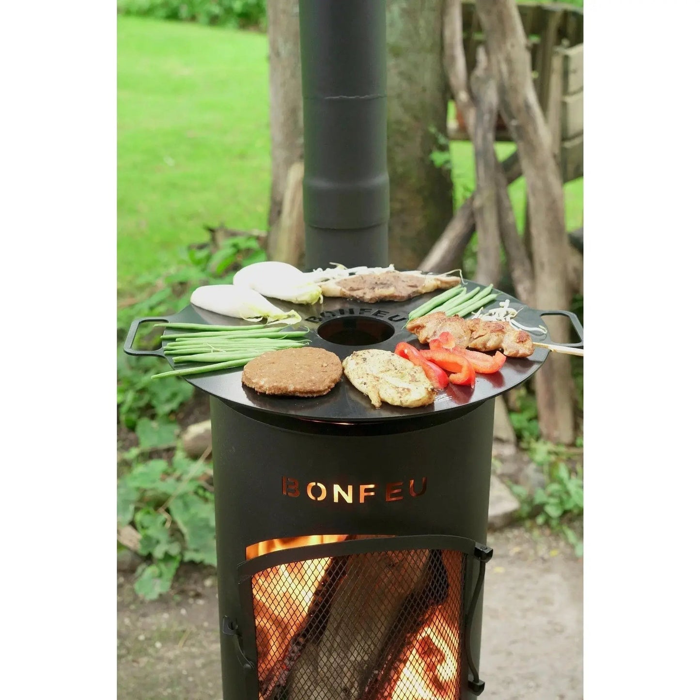 Black bonfeu bongiano sp outdoor fireplace with circular cooking surface and visible flames in black and corten steel