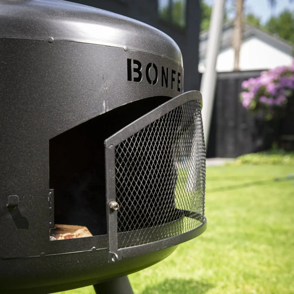 Black metal fire pit with mesh door and bonfeu branding bonfeu bongiro compact outdoor fireplace 5501