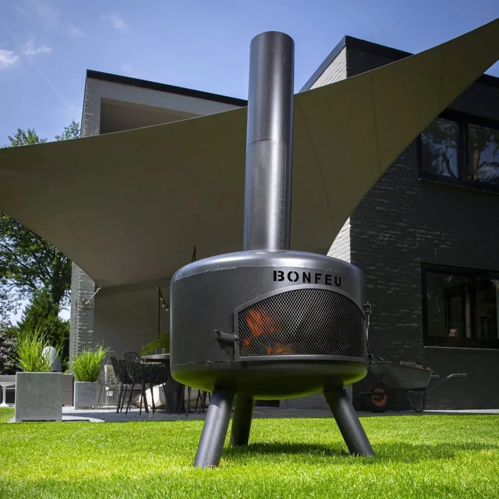 Bonfeu bongiro compact outdoor fireplace with cylindrical stainless steel body and tripod legs in sleek modern design
