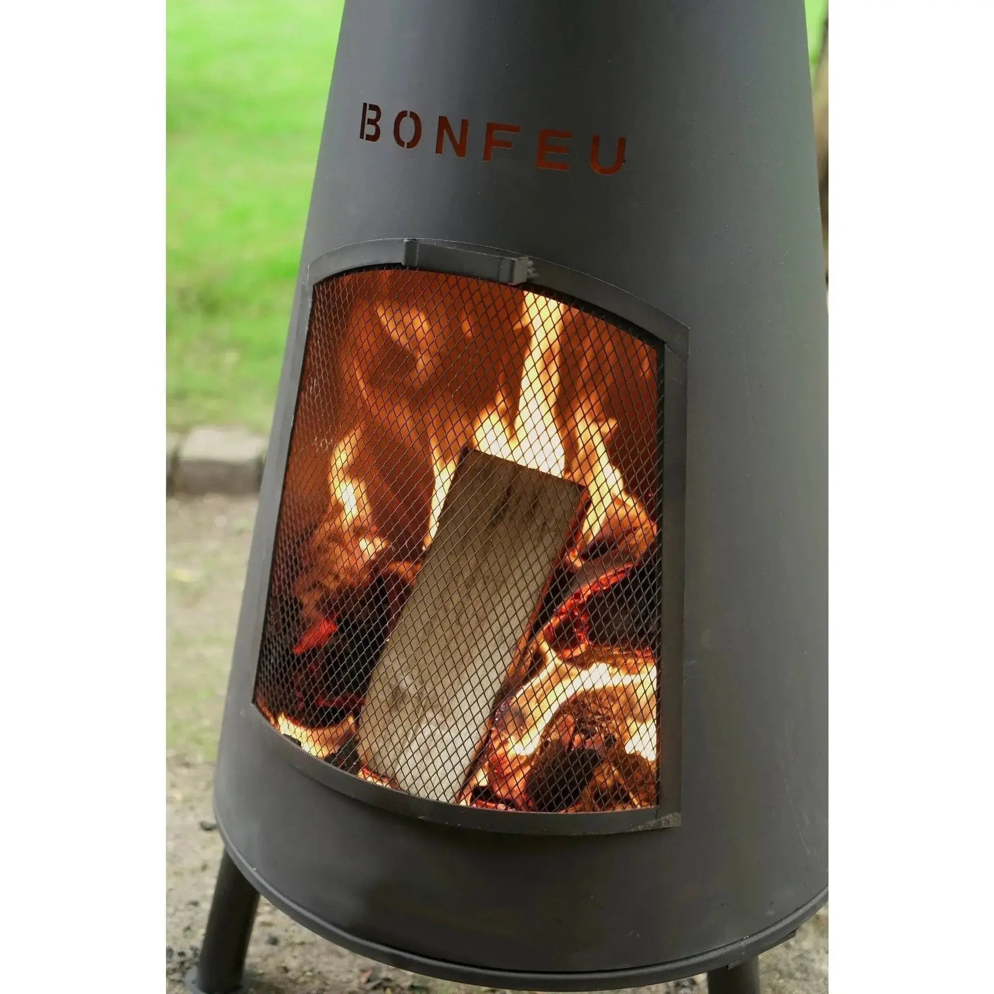 Dark gray metal bonfeu bonpyra large cone-shaped outdoor fireplace with mesh screen and visible flames inside