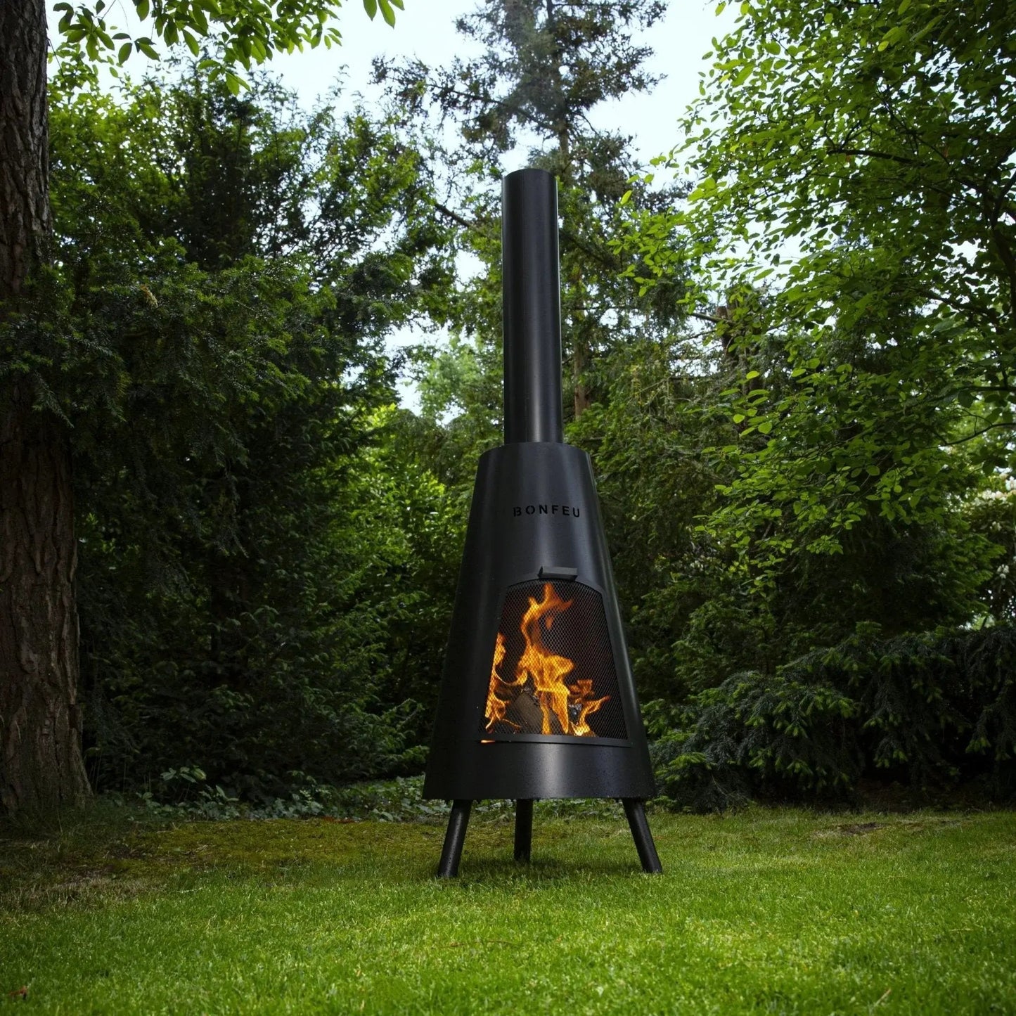 Black metal bonfeu bonpyra large outdoor fireplace with conical design and visible flames inside