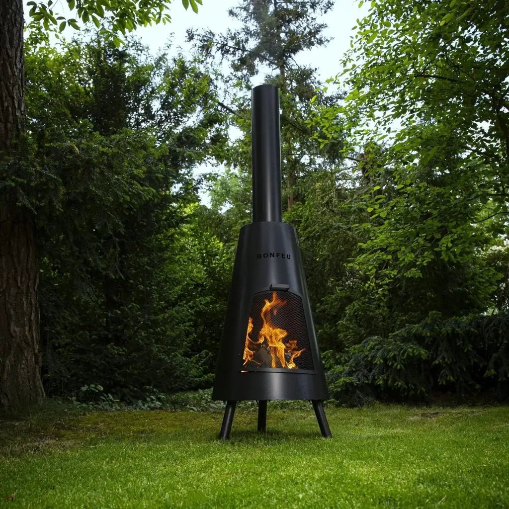 Black metal bonfeu bonpyra large outdoor fireplace with conical design and visible flames inside