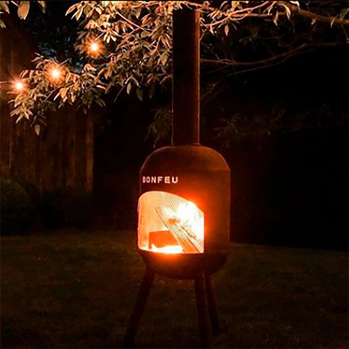 Rustic corten steel bonfeu bonsolo outdoor fireplace fire pit with glowing orange interior and ionfeu branding