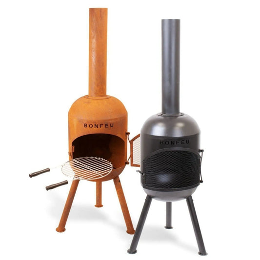 Two bonfeu bonsolo outdoor fireplaces with tall chimneys and tripod bases in black matte and rusted corten steel finish