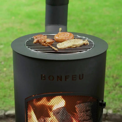 Black metal BonFeu BonTino LP outdoor fireplace with chimney and visible fire inside in black finish