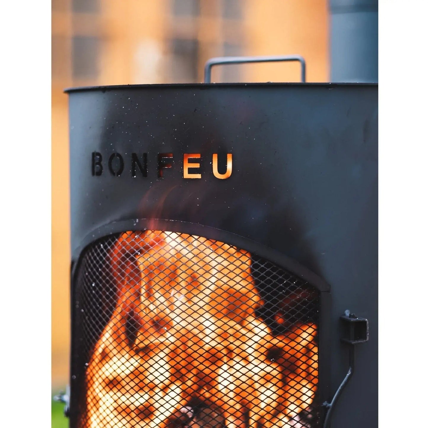 Black metal BonFeu BonTino LP outdoor fireplace with mesh screen and glowing embers inside